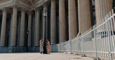 a man filming a woman with a vintage camera