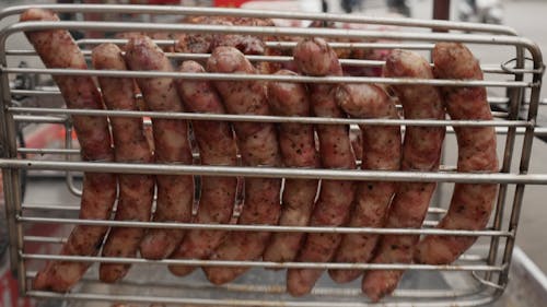 Quickly Rolling Sausages on Barbecue