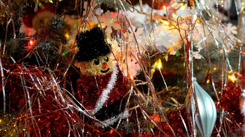 Close up on Christmas Ornament among Flashing Lights