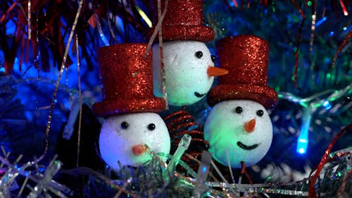 Close up on Christmas Snowmen among Flashing Lights