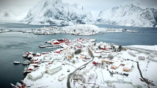 An Aerial Footage of Snow Covered Mountains and Houses