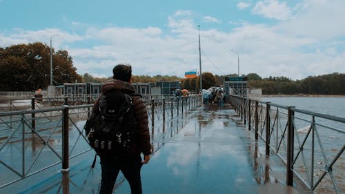 Back View of a Person Walking on a Landing STage