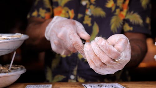 Close up on Person Cutting Clams