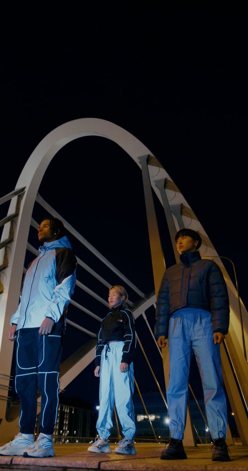 Low angle view on man and women standing in city at night