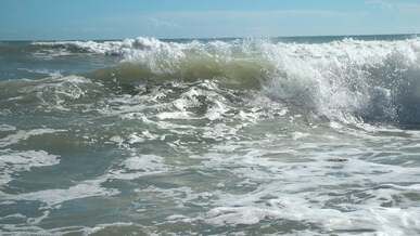 high waves reaching shore