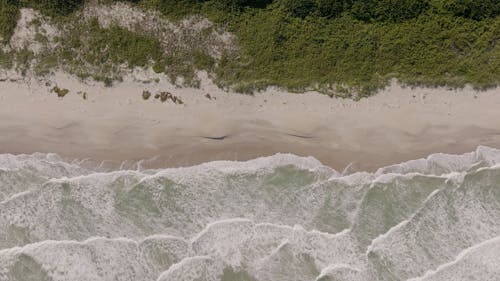 View from Above on Waves Reaching Sea Shore