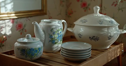 Close up of a Person Placing a Lid on a Teapot