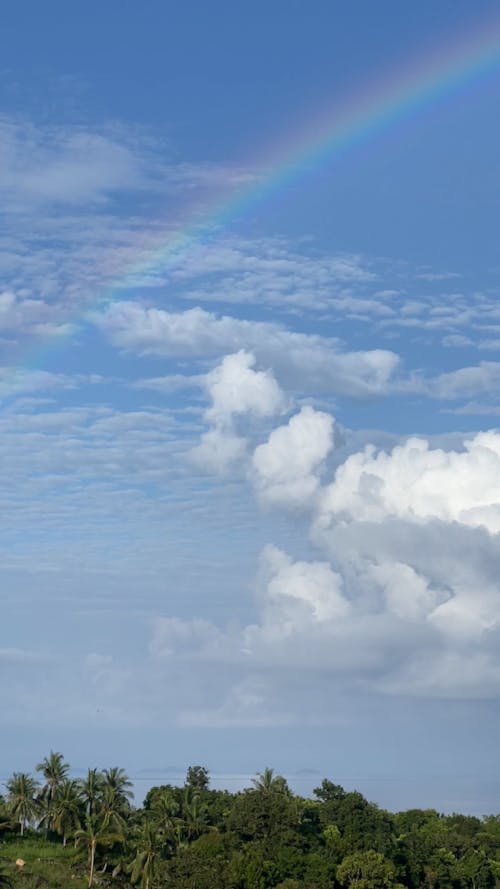White Clouds and a Rainbow over the Ocean 
