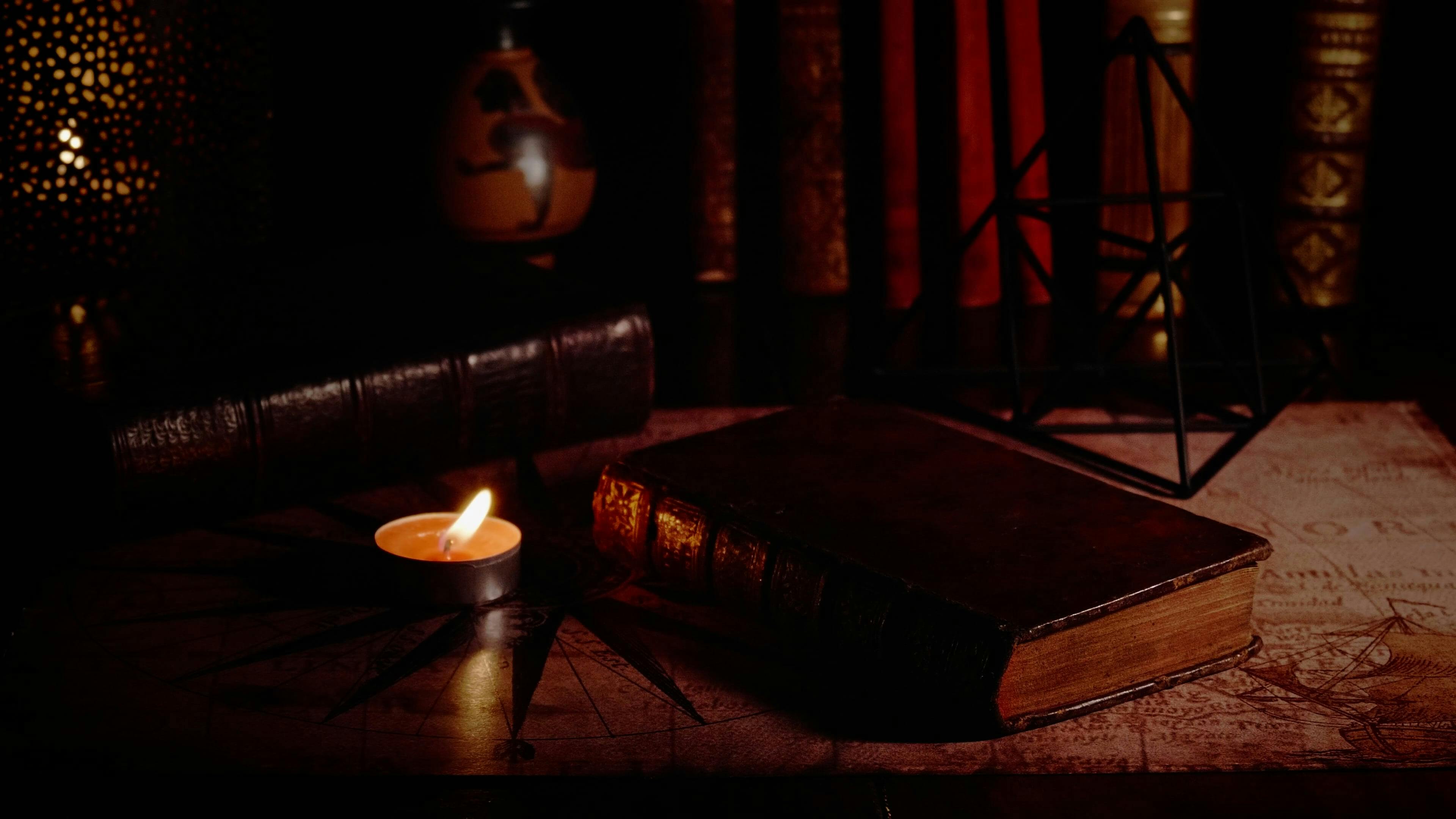 Old Books and Burning Candle · Free Stock Video