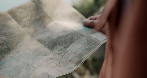 An Elderly Man and a Boy using a Paper Map