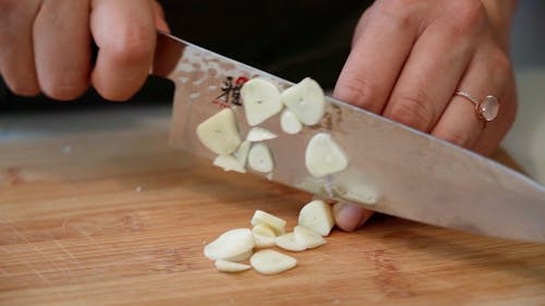 Close-up of a Person Chopping Garlic