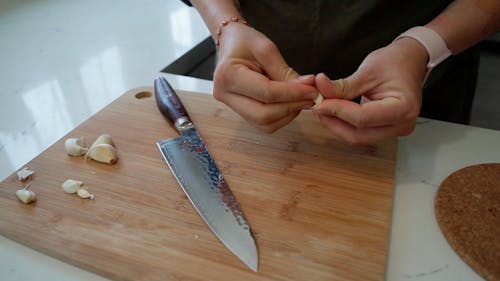 A Person Peeling Garlic