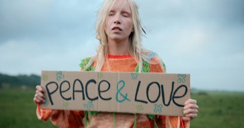 A Hippie Couple Holding up Signs