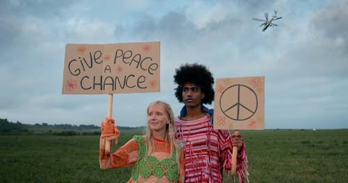 Hippies Holding Cardboard Signs