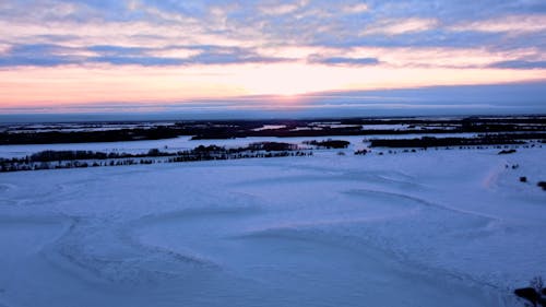 Beautiful Sunset over Snowy Winter Landscape