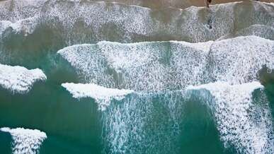 aerial footage of waves crashing on shore
