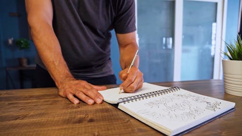 Man Writing on a Notebook