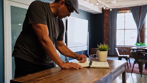 Man Sketching on a Notebook