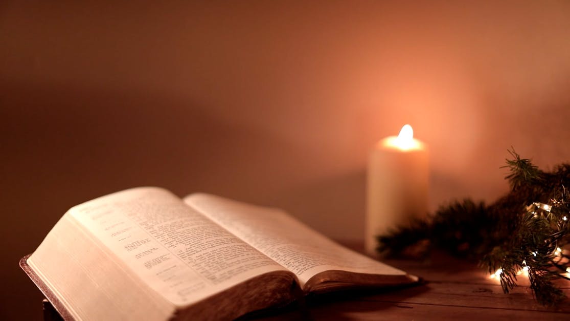 open bible with candle