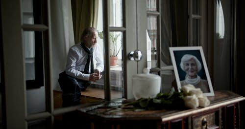 A Grieving Man Sitting by the Window