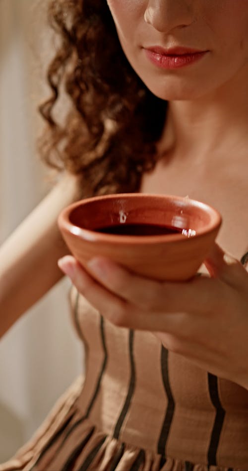 A Woman Drinking Wine from a Cup