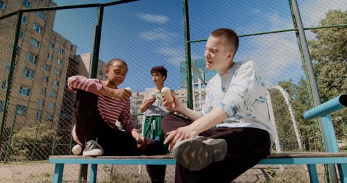 Boys Having Conversation while Eating Ice Cream