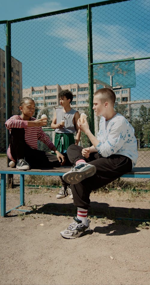 Boys Having Conversation while Eating Ice Cream