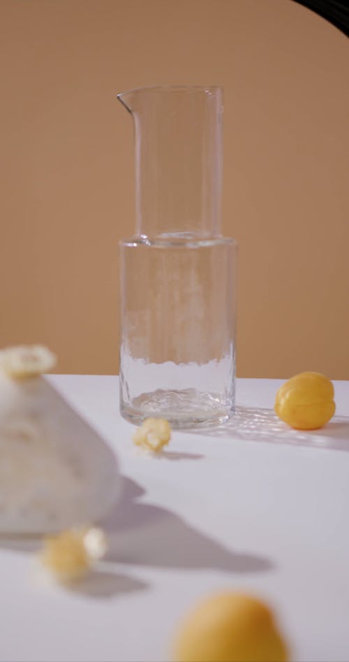 A Person Pouring a Beer in a Glass Pitcher