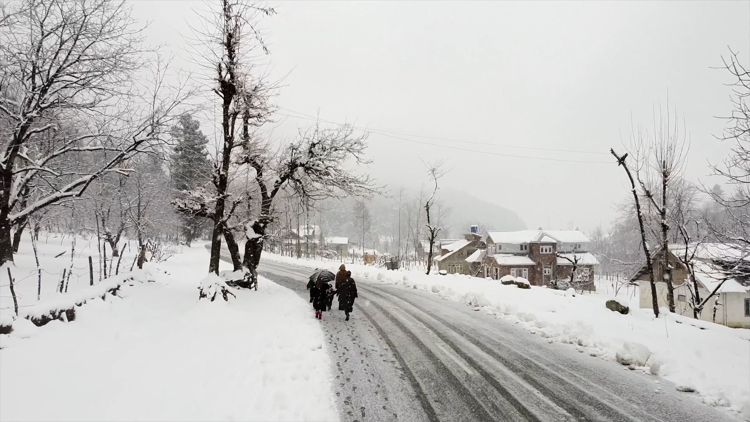 A Group of People Walking on a Snow Covered Road Free Stock Video ...