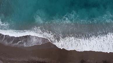 top view of breaking waves on the beach