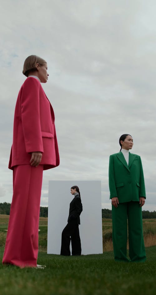 Low Angle View on Women in Suits by Wall on Grass