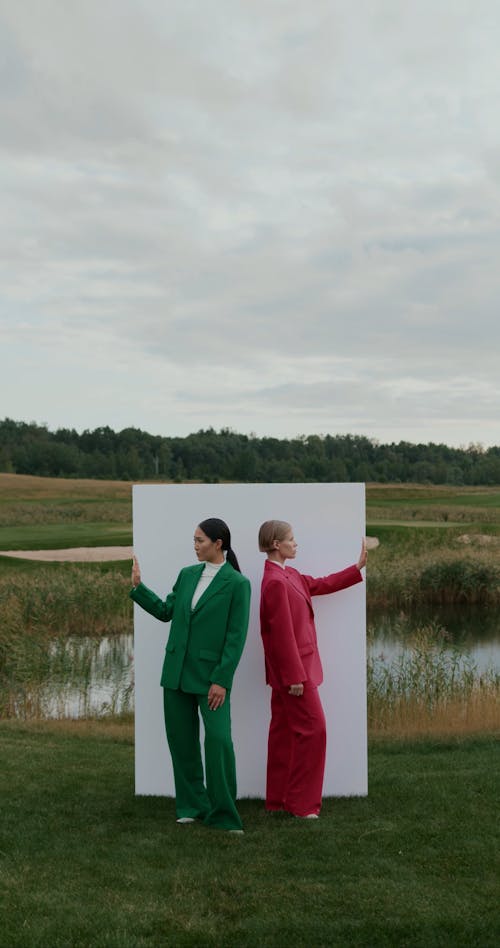 Women with Raised Arms by Wall on Grass