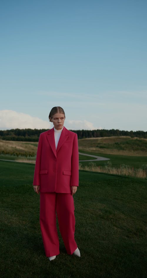 Women in Suits Standing and Walking on Grass