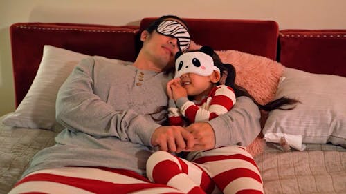 Father and Daughter Wearing Sleep Mask