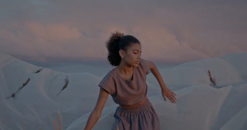 Woman Dancing with Fabric Waving in Wind