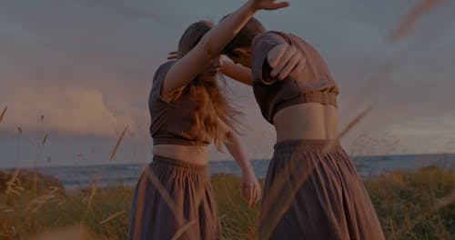 Women Performing in Seaside at Sunset