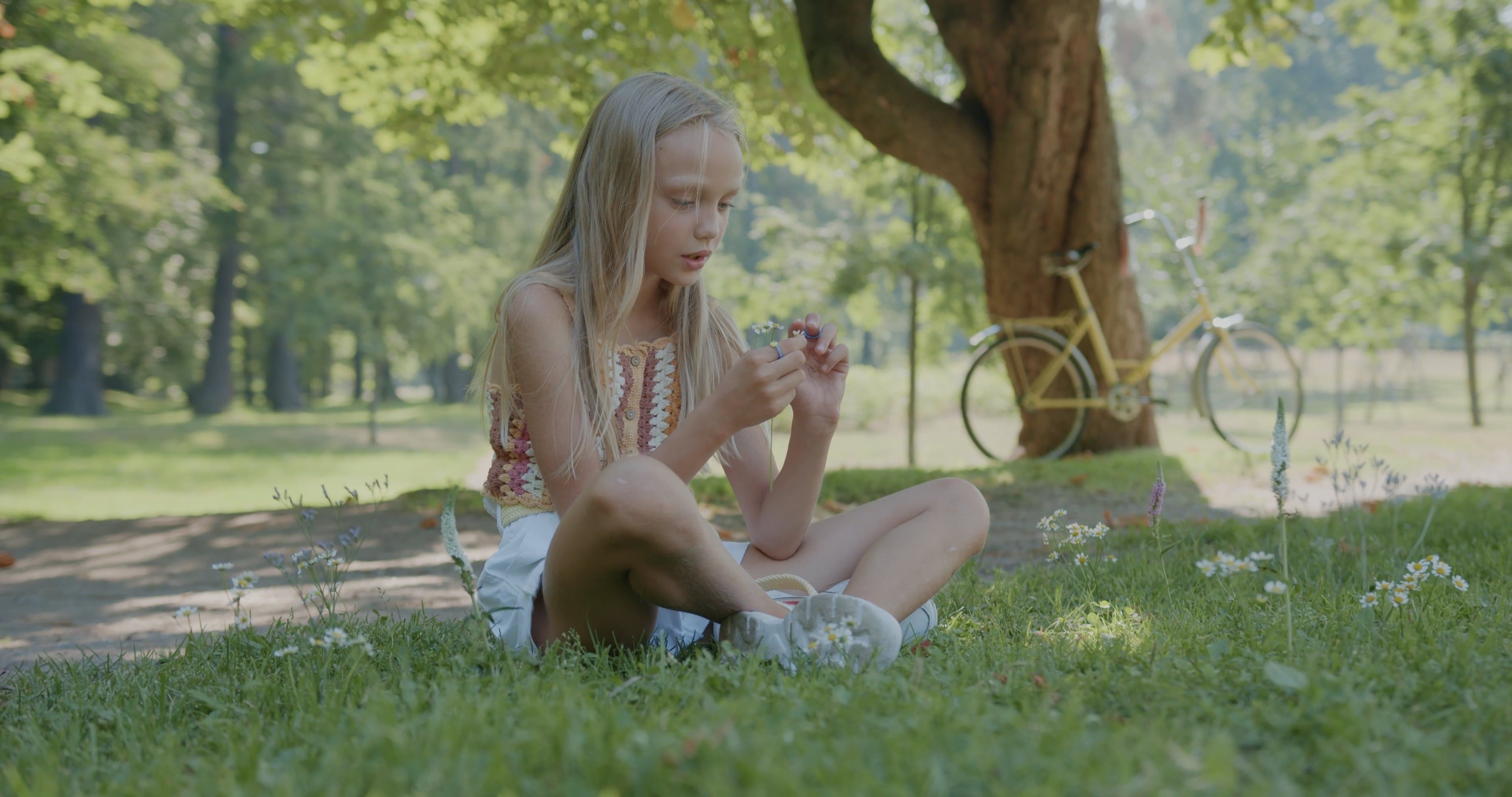 A Young Girl Holding and Smelling Small White Flowers Free Stock Video ...