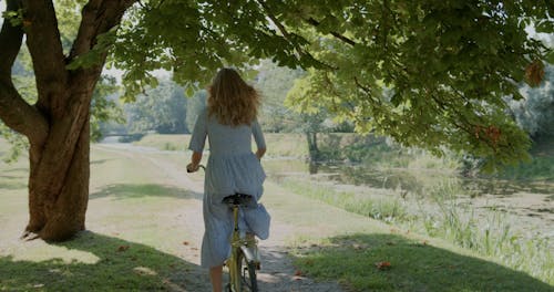 A Teenage Girl Arriving at a Park in her Bicycle