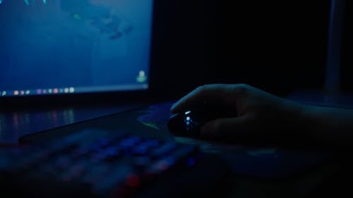 Close-up View of Man Playing on Computer at Night
