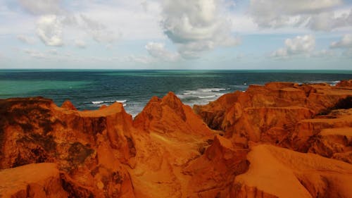 Aerial Footage of Red Rock Formations by the Sea 