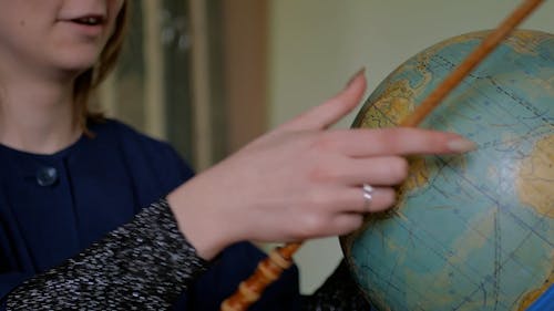 Girl Learning Geography with Globe
