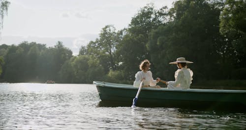 Two Persons Riding a Boat while Having Conversation