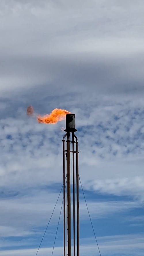 A Flare Stack under a Cloudy Sky