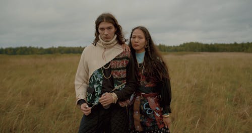 A Gypsy Couple Standing Close Together in a Field