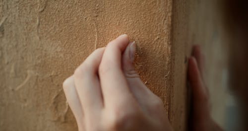 A Person Carving a Word on a Wall