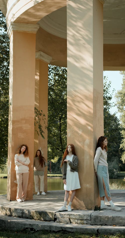 Young Women Posing on Columns