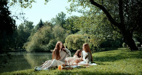 Young Women Having a Picnic by a Lake
