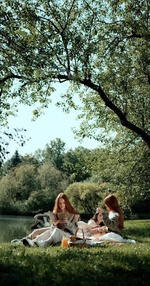 Young Women Having a Picnic by a Lake