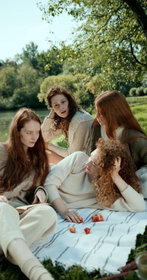 Young Women Having a Picnic by a Lake