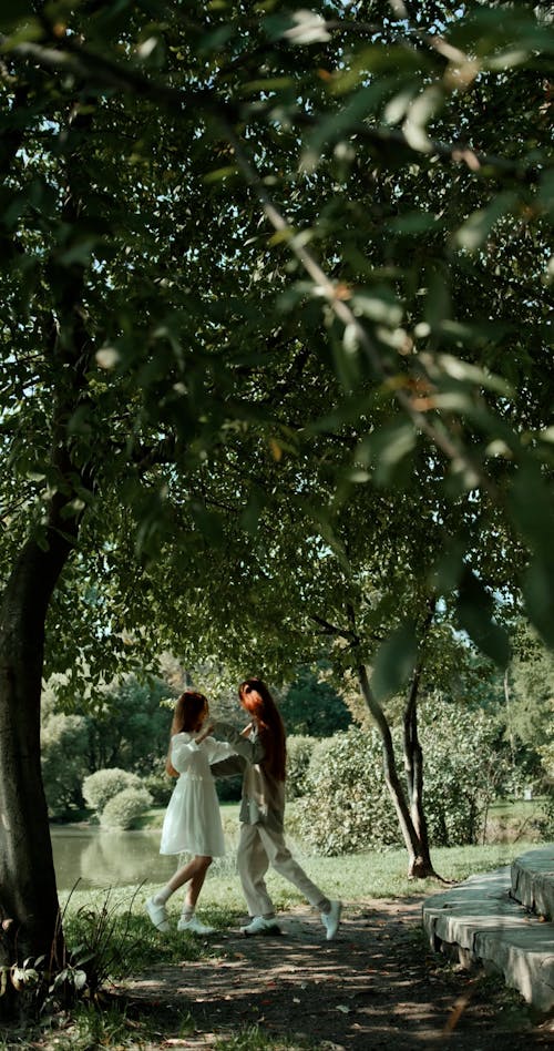 Young Women Dancing and Playing Together at a Park